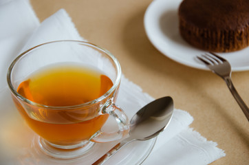 Glass Cup of Tea and Chocolate Cake for Tea Break.