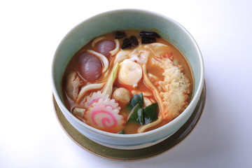Tom Yum seafood udon isolated on white background. Thai style sp