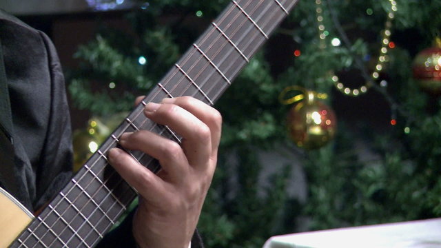 playing guitar,close-up,on the Christmas tree.