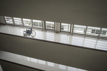Wheelchair standing in an empty hospital corridor