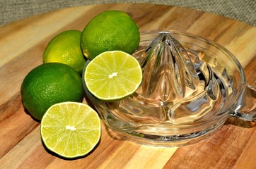 Cut and whole lime with glass juicer