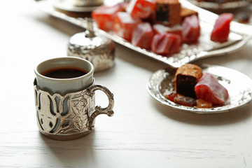 Antique tea-set with Turkish delight on table close-up