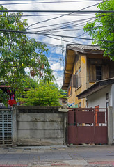 Old wooden house with electriciy lines and satellite dishes