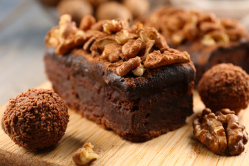 Obraz na płótnie Canvas A piece of chocolate cake with walnut on the table, close-up
