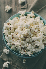 Popcorn and cola on the wooden table