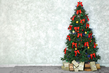 Decorated Christmas tree on light wall background