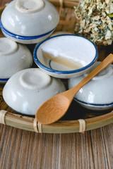 Thai dessert made of coconut milk on wood basket, Steamed Pandan