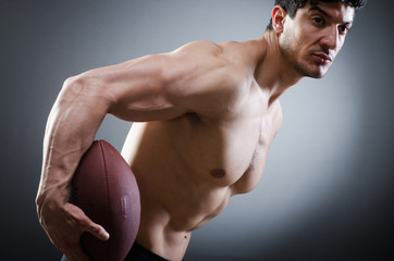 Muscular man with american football
