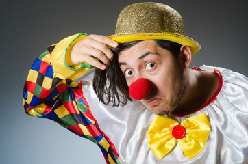 Funny clown against dark background