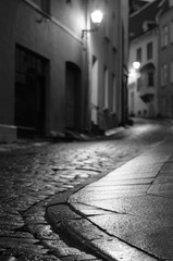 Illuminated night city street of old european town