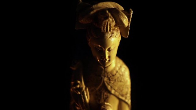 Asian statuette with candle light 