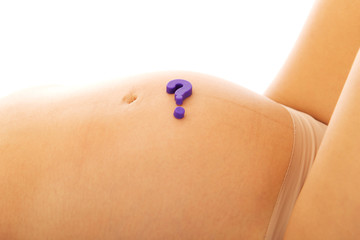 Belly of pregnant woman with question mark