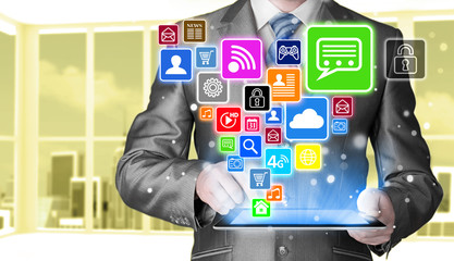 Business man using tablet PC with social media icon set