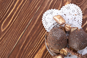 Cupcake with chocolate on wooden background