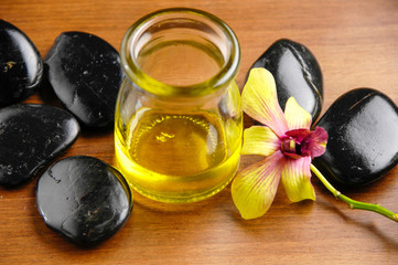 Fototapeta na wymiar Orchid and stones ,massage oil on board