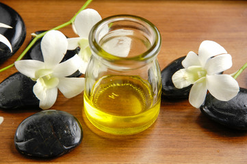 Fototapeta na wymiar White orchid and stones ,massage oil on board