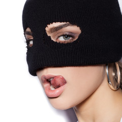 Close-up of face of sexy woman in balaclava - crime and violence