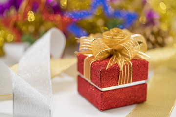 Red Christmas gift box with bokeh background
