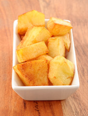 chunks of chips in small porcelain bowl on wooden classic