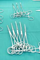 Detail shot of steralized surgery instruments with a hand grabbing a tool