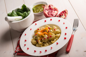 pasta with pesto pomegranate and sliced carrot