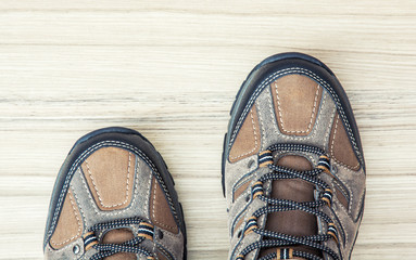 New teenage outdoor shoes on the wooden background, detail photo