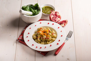 pasta with pesto pomegranate and sliced carrot
