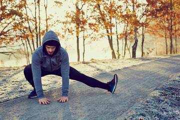 Male runner doing stretching exercise