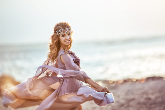 Portrait of a girl in a fairy light dress on a sunset
