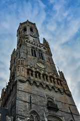 Fototapeta na wymiar Belfry tower in Bruges on a beautiful cloudy day