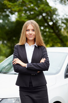 Woman standing by her car