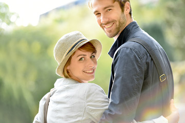 Young in love couple walking in city park