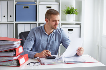 Man calculates taxes in office