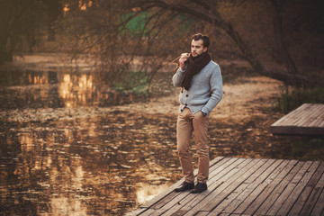Fototapeta premium handsome man in autumn park