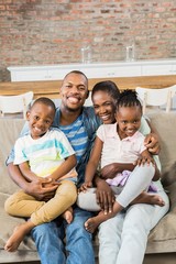 Happy family relaxing on the couch