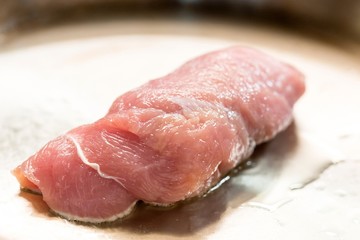 cooking meat in a frying pan