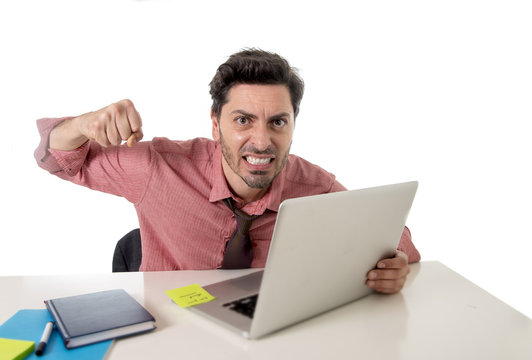 businessman at office working stressed on computer laptop overworked throwing punch in work stress