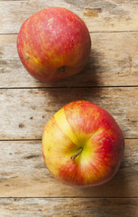 Ripe red apples on wooden background close up