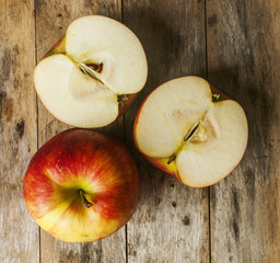 Ripe red apples on wooden background