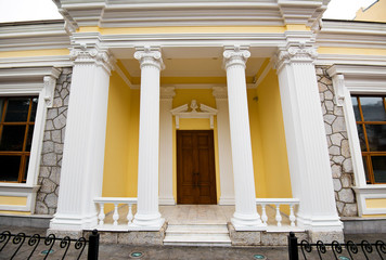 The entrance is decorated with columns.