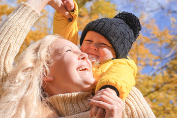 Obraz premium Mother and son walking in the autumn park