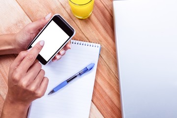 Overhead of feminine hands using smartphone
