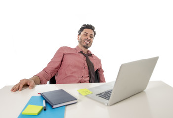 young happy and attractive businessman in shirt and tie sitting at office desk working with computer laptop
