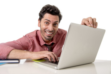  happy attractive businessman in shirt and tie at office desk working with computer smiling