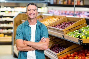 Portrait of a smiling man with arms crossed