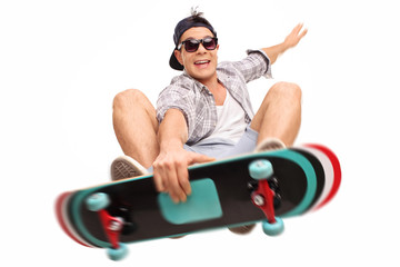 Skater performing tricks with his skateboard - obrazy, fototapety, plakaty