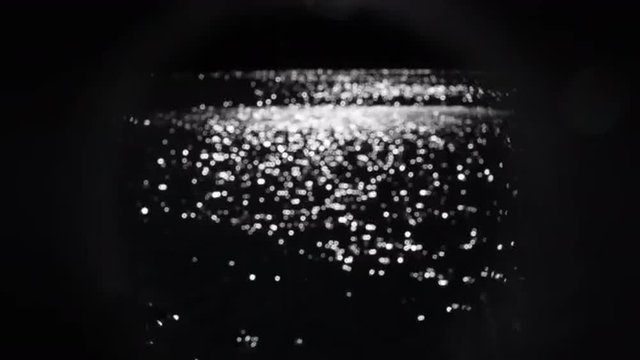Glittering natural pattern with small shining sparkles on dark water background in sunny day. Artistic fast moving pattern for your design. Loopable. Full HD footage 1920x1080
