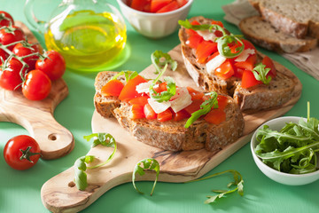 italian bruschetta with tomatoes parmesan arugula