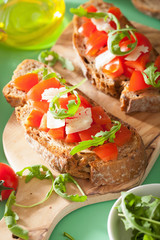 italian bruschetta with tomatoes parmesan arugula