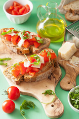italian bruschetta with tomatoes parmesan arugula